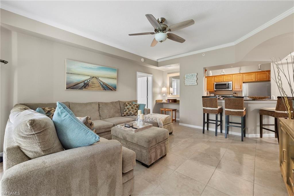 12955 Positano Circle, Unit 104 Naples, FL 34105 - Photo 3 of 40 a living room with furniture and a large window