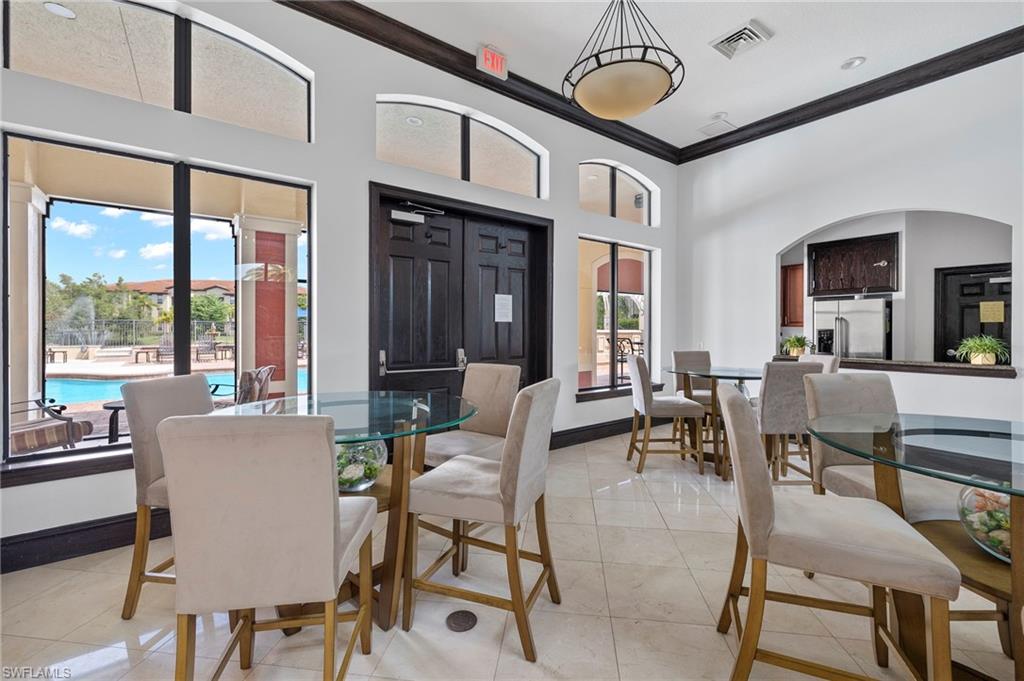 12955 Positano Circle, Unit 104 Naples, FL 34105 - Photo 39 of 40 a view of a dining room with furniture window and outside view