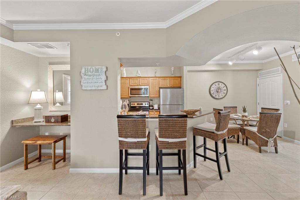 12955 Positano Circle, Unit 104 Naples, FL 34105 - Photo 6 of 40 a dining room with furniture and window