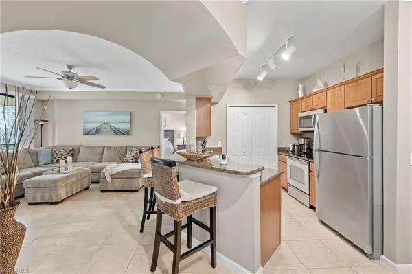 a kitchen with a refrigerator a stove a dining table and chairs