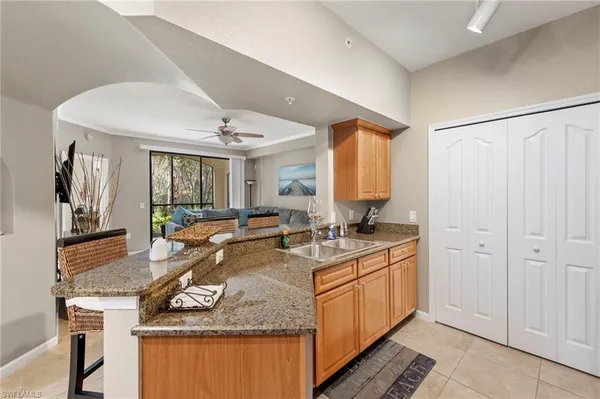 a spacious bathroom with a granite countertop sink and a mirror