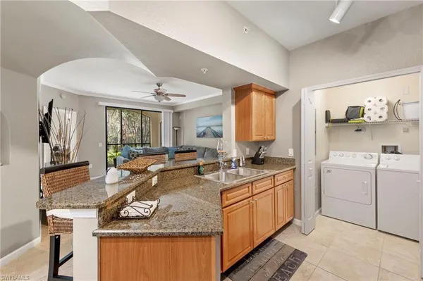 a kitchen with a stove sink and cabinets