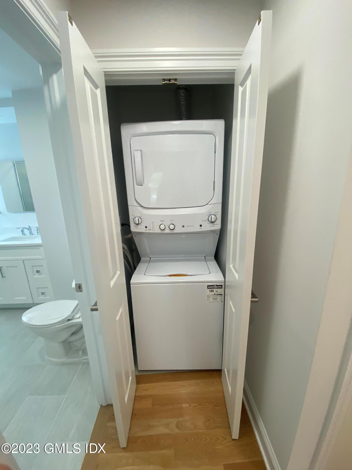 36 Arch Street, Unit 2A Greenwich, CT 06830 - Photo 7 of 7 a white toilet sitting in a bathroom next to a sink