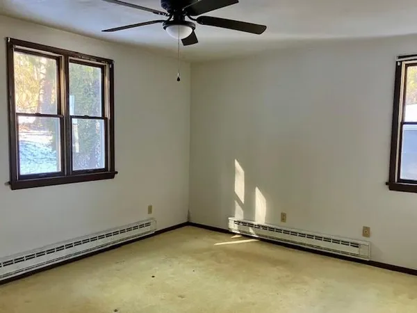 an empty room with a empty space and windows