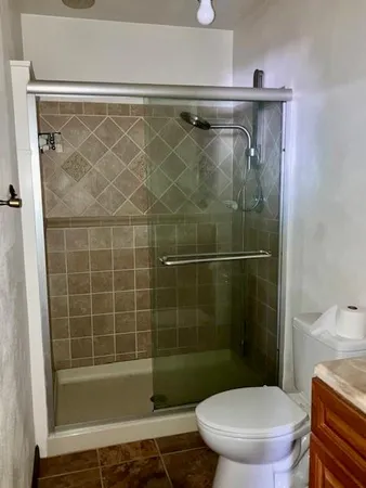 a bathroom with a shower a toilet and a sink