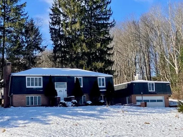 a view of a house with a yard covered in snow