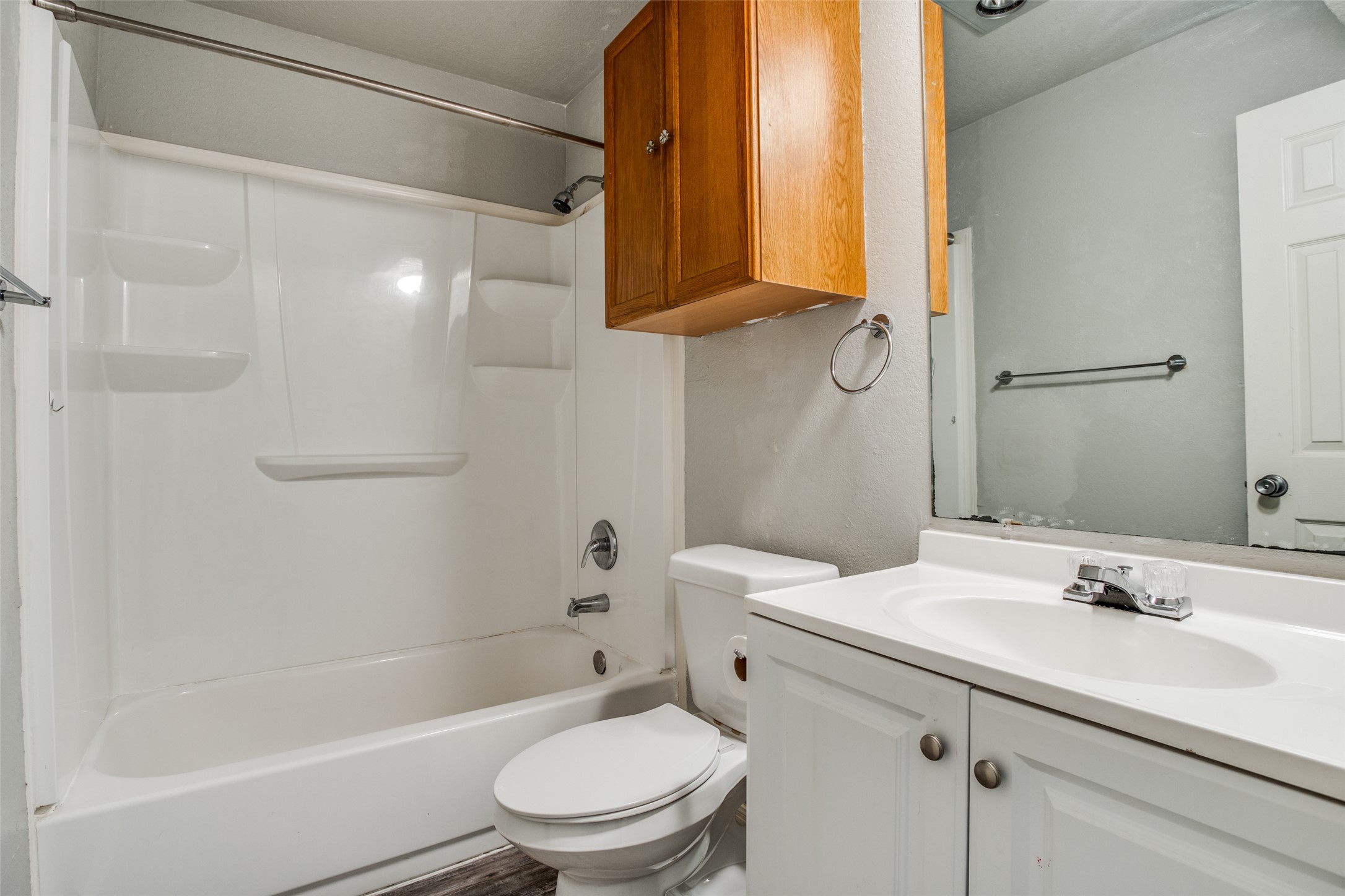 106 Verna Spur, Unit B Georgetown, TX 78628 - Photo 15 of 25 Functional full bathroom featuring a combined tub and shower unit, vanity with a basin sink, and ample overhead storage.