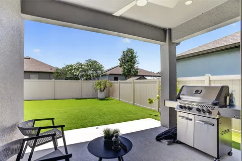 a view of a house with a yard and deck
