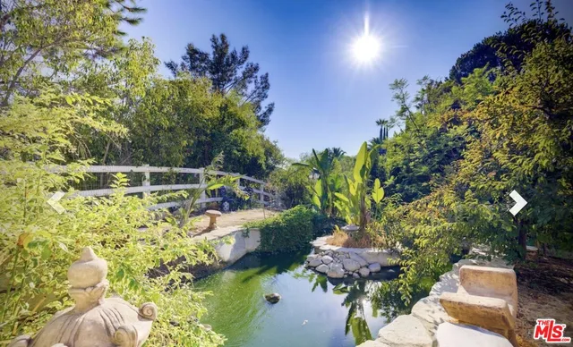 a backyard of a house with lots of green space and outdoor seating