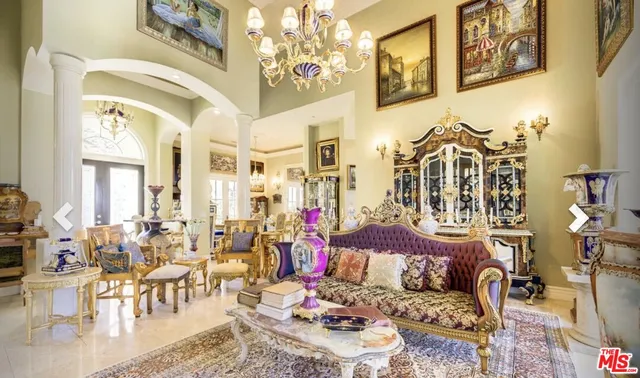 a living room with furniture and a chandelier