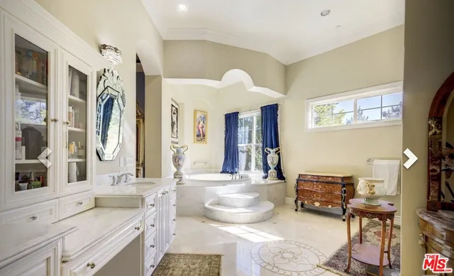 a spacious bathroom with a double vanity sink double mirror and a