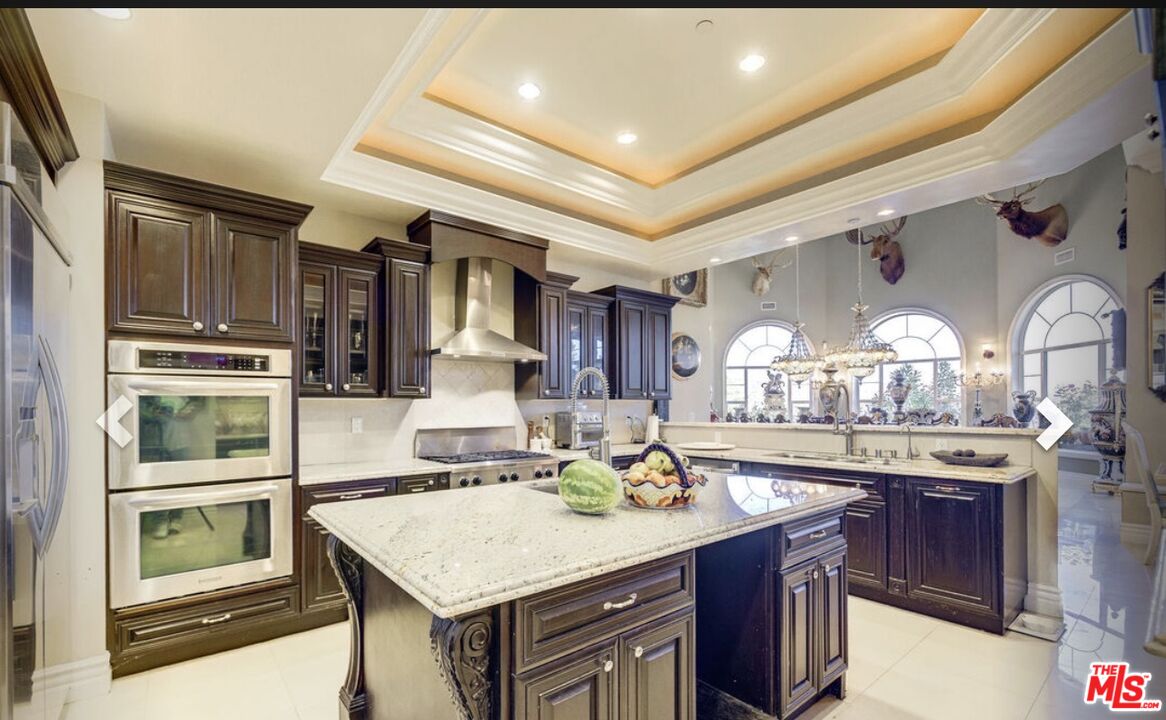 232 Saddlebow Road Bell Canyon, CA 91307 - Photo 6 of 20 a kitchen with stainless steel appliances granite countertop a sink and cabinets
