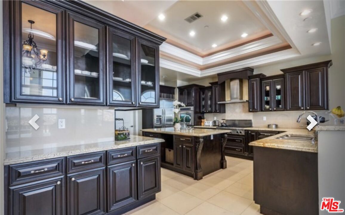 232 Saddlebow Road Bell Canyon, CA 91307 - Photo 8 of 20 a kitchen with stainless steel appliances granite countertop a sink and cabinets
