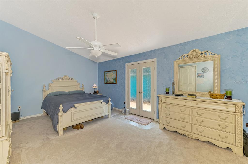 1137 Ponderosa Road Venice, FL 34293 - Photo 22 of 48 a spacious bedroom with a bed and a table