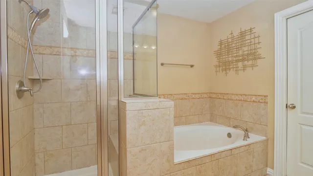 a bathroom with a tub shower and sink