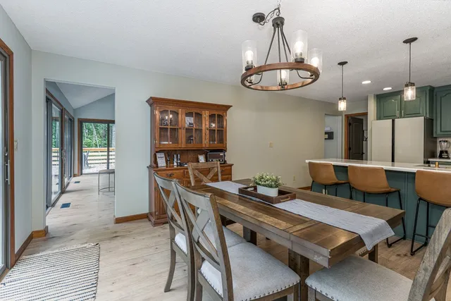a view of a dining room with furniture wooden floor and chandelier