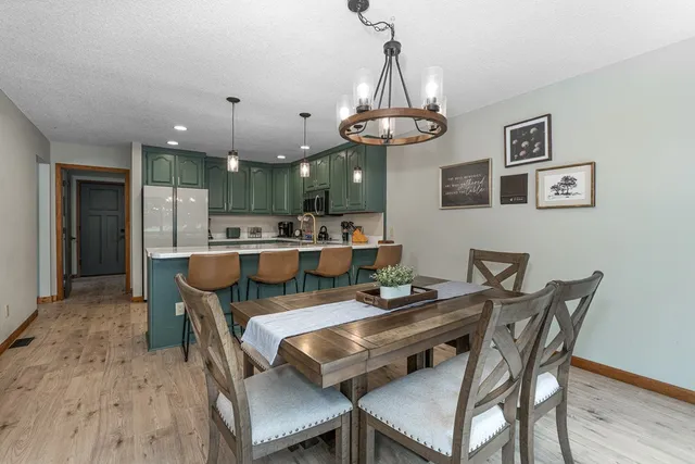 a kitchen with kitchen island a stove a sink a refrigerator and a refrigerator