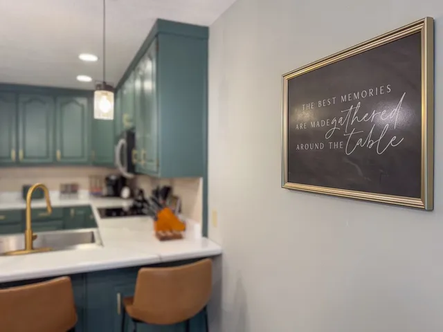 a kitchen with a sink a stove and cabinets