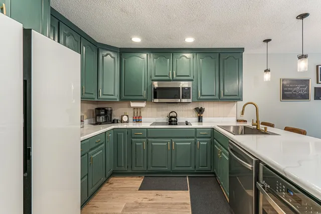 a kitchen with a stove sink and microwave