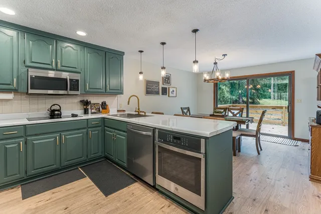 a bathroom with a glass door shower and a sink
