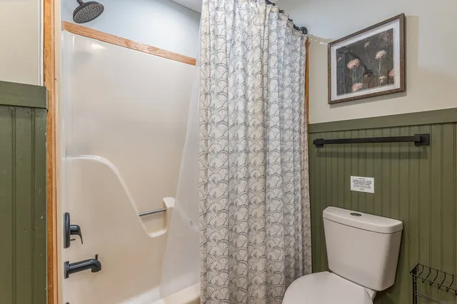 a bedroom with a bed and a flat tv screen in it