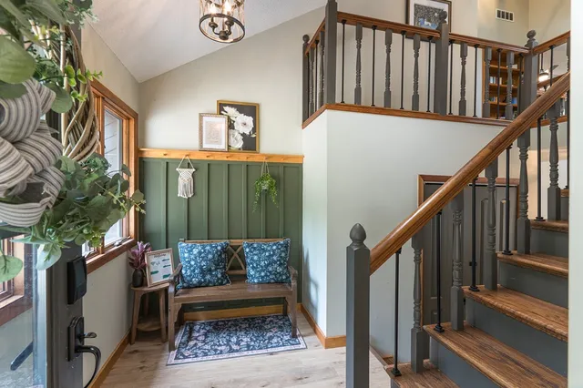 a view of staircase with wooden floor and a potted plant