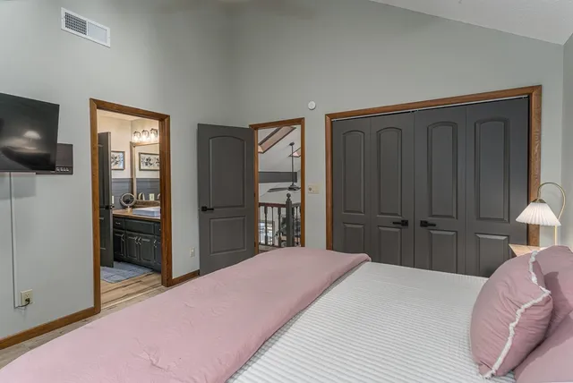 a view of a hallway with wooden floor and closet