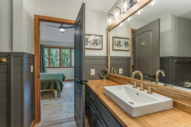 a room with furniture pool table flat screen tv and windows