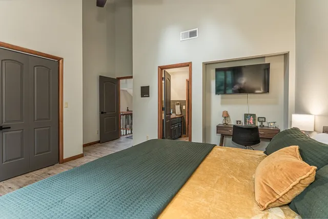 a bedroom with a bed and a flat screen tv