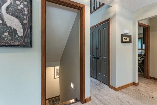 a bedroom with a bed and a painting on the wall