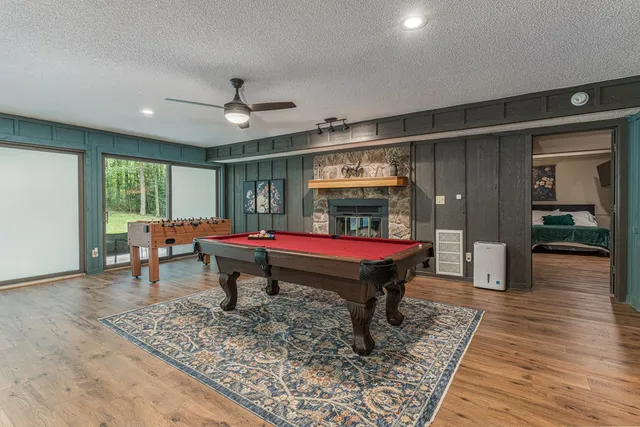 a bedroom with a large bed a rug and a painting on the wall