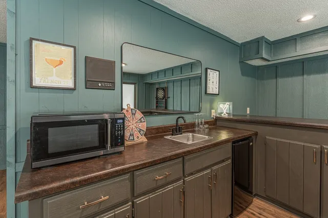 a view of a house with a yard and sitting area