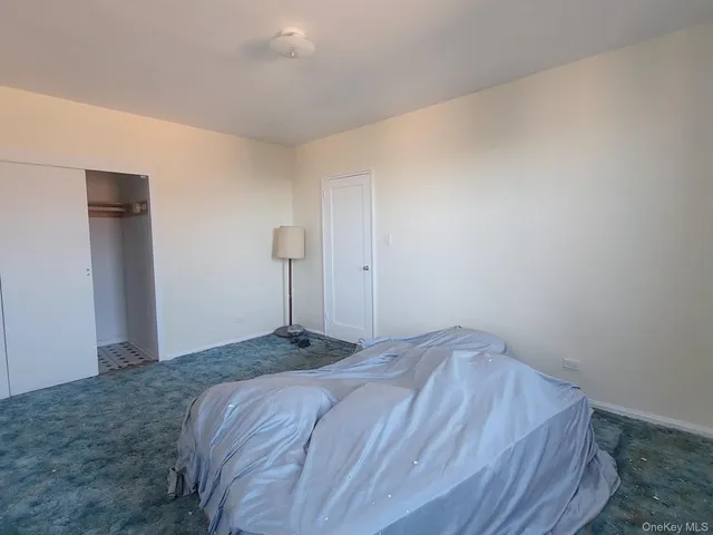 a bathroom with a sink a toilet a mirror and shower