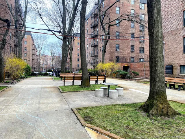 a view of a fountain in front of a brick building
