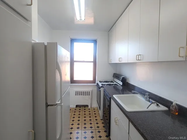 a kitchen with sink cabinets and window