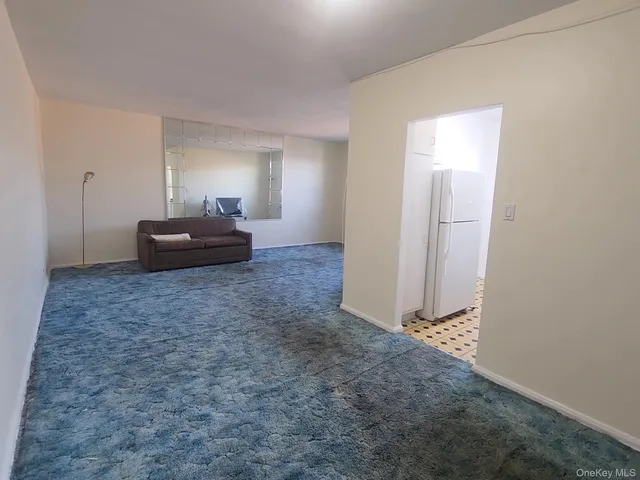 a bedroom with a bed and a mirror