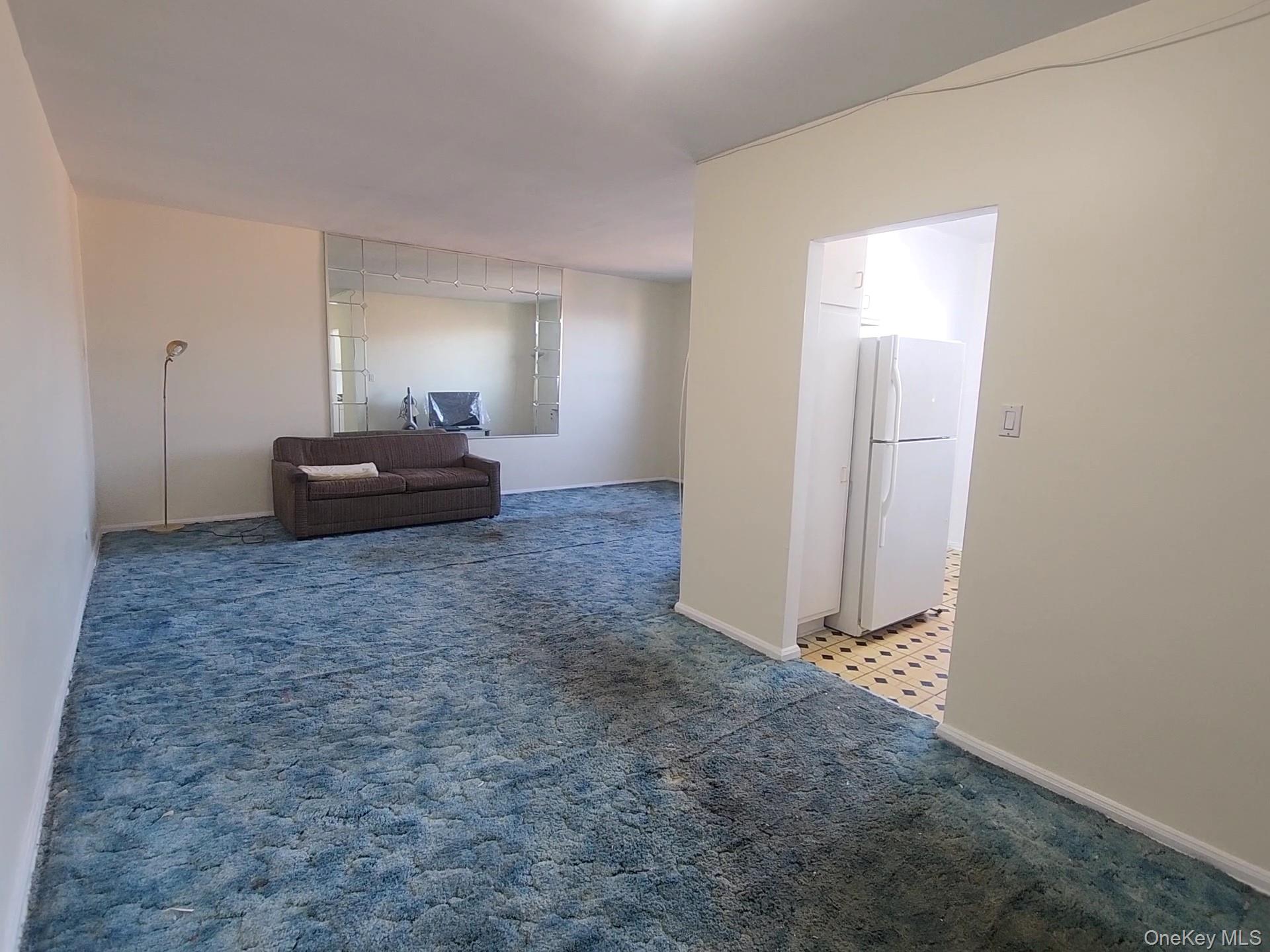 90-09 Northern Boulevard, Unit 605 Queens, NY 11372 - Photo 5 of 16 a bedroom with a bed and a mirror