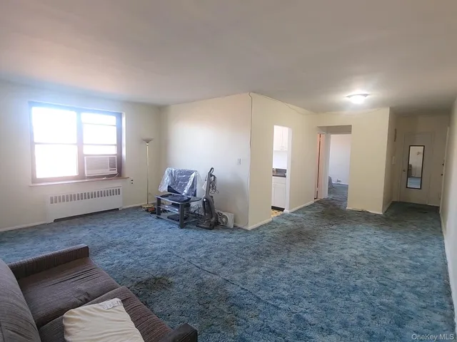 a view of a livingroom with furniture and a window