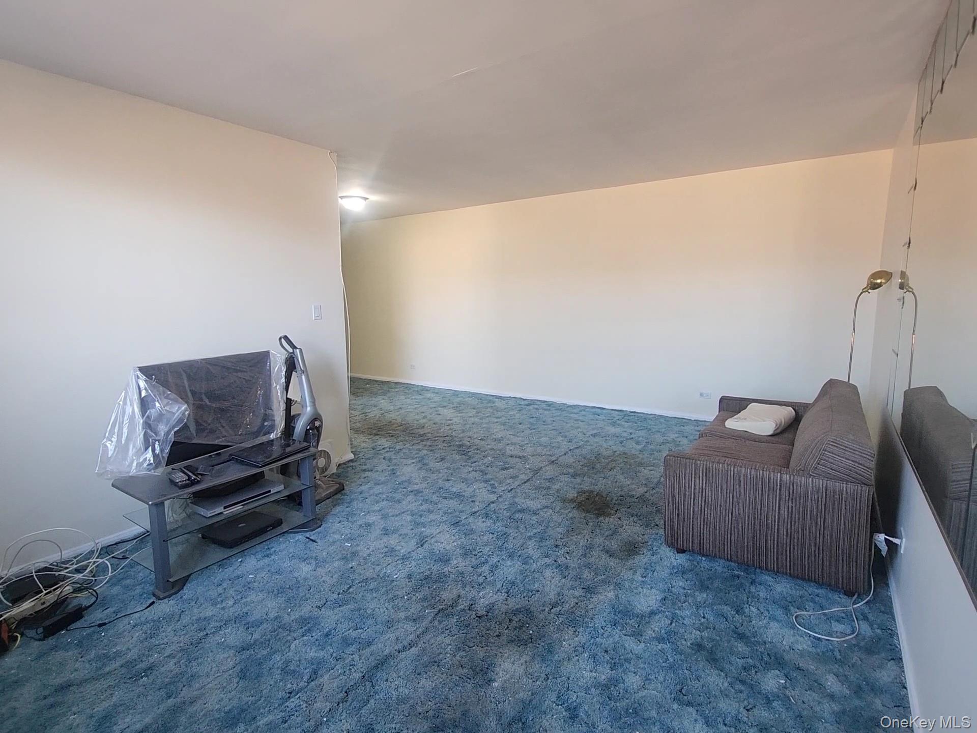 90-09 Northern Boulevard, Unit 605 Queens, NY 11372 - Photo 7 of 16 a living room with furniture and a couch