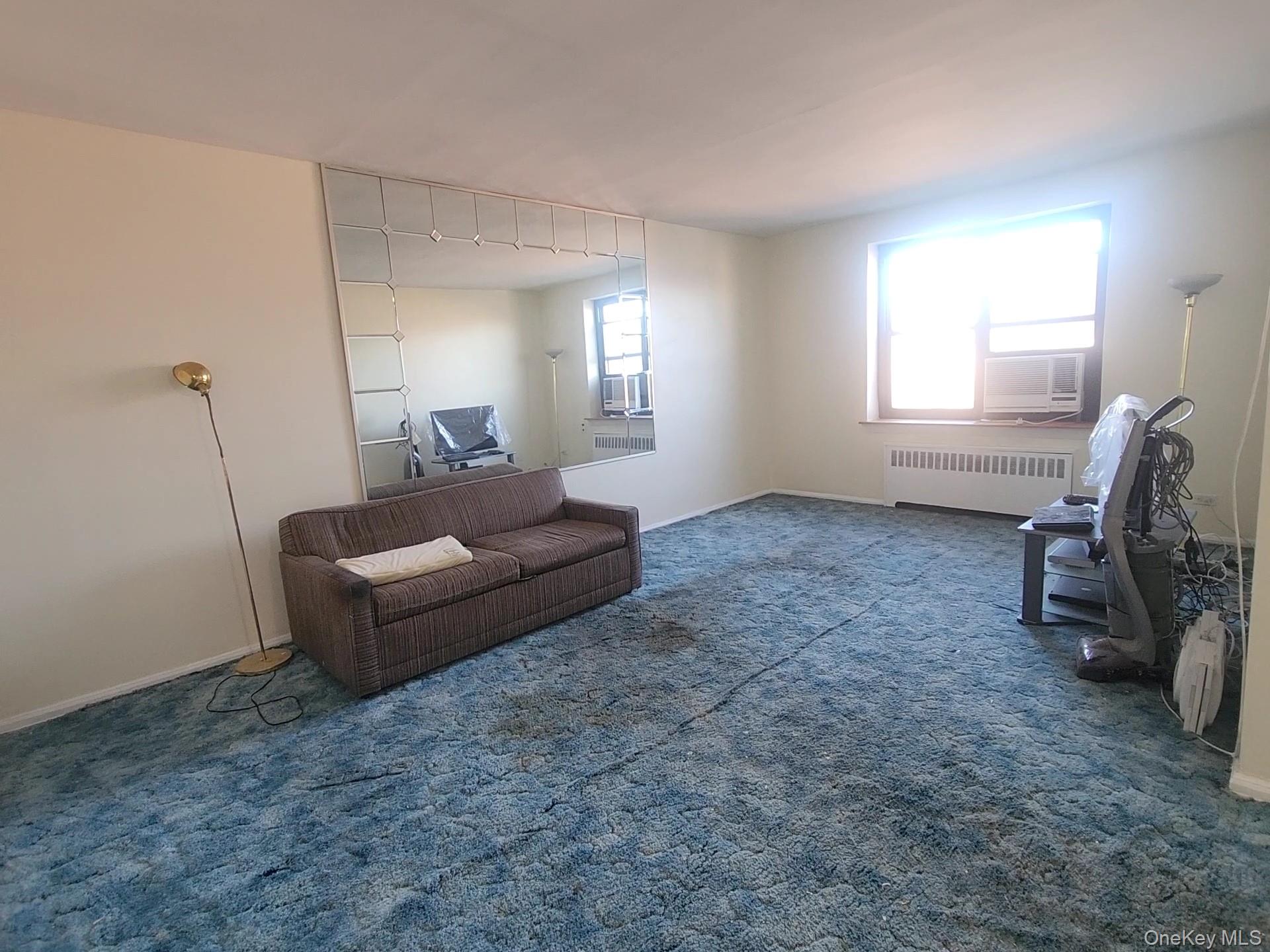 90-09 Northern Boulevard, Unit 605 Queens, NY 11372 - Photo 8 of 16 a living room with furniture and a window