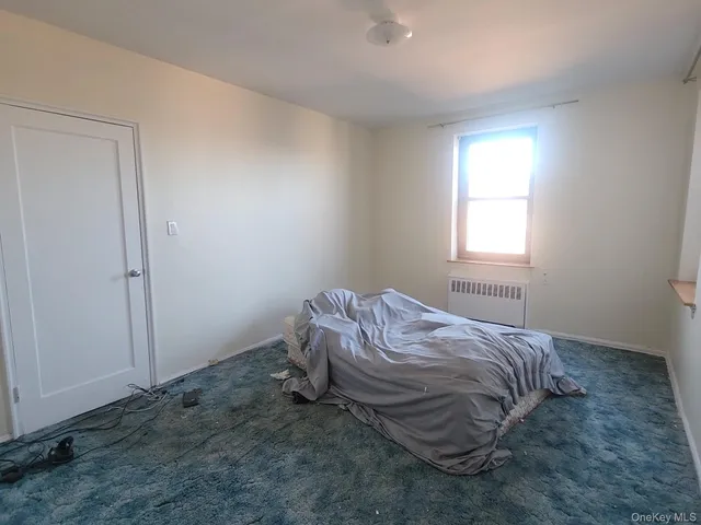 a bedroom with a bed and a wall painting