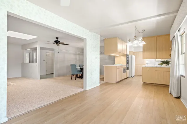 a view of a kitchen with wooden floor and a kitchen