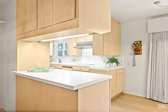 a kitchen with stainless steel appliances granite countertop a sink and a stove