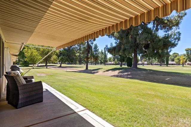 a swimming pool with outdoor seating and yard