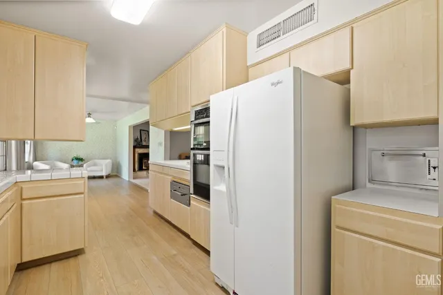 a kitchen with a refrigerator a stove top oven a washer and dryer
