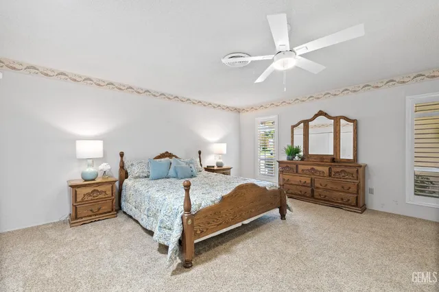 a spacious bedroom with a bed and a chandelier