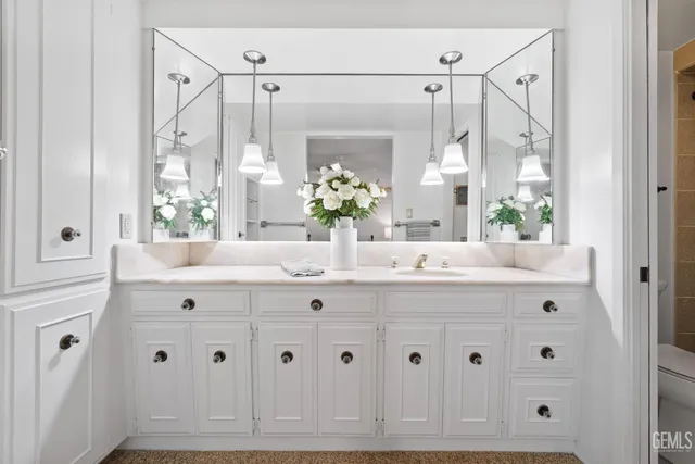 a bathroom with double vanity sink a mirror a window and a shower