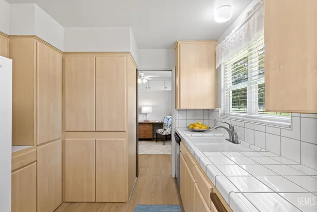 a kitchen with stainless steel appliances a stove a sink and a refrigerator