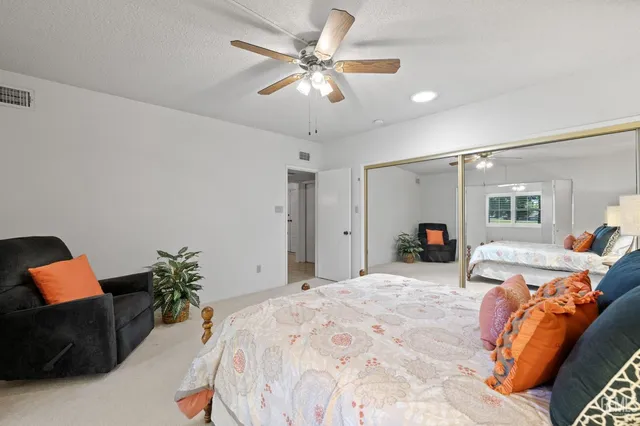 a bed room with a bed window and a chair