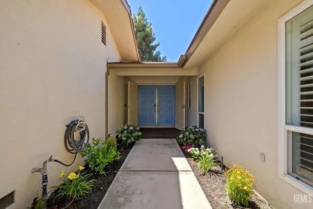 a view of a entryway door with flower pots
